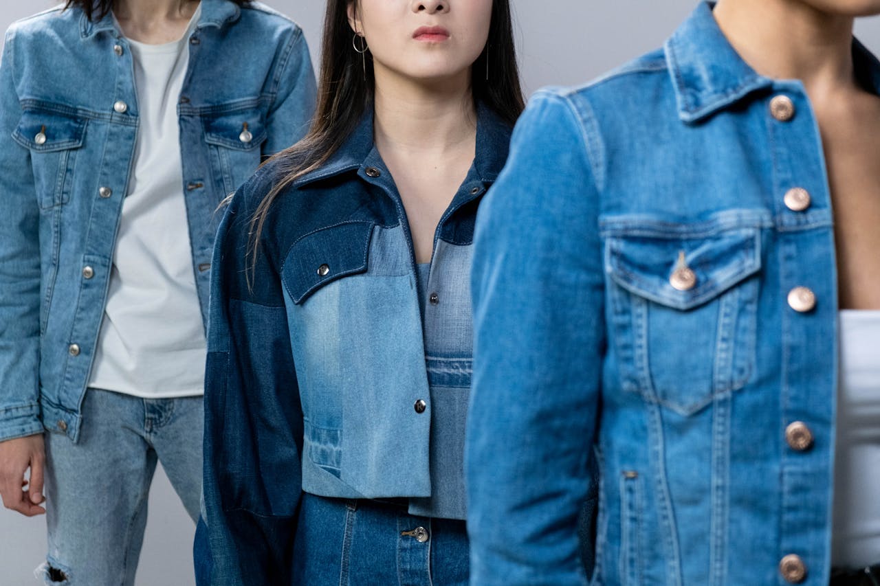 Group of young adults in fashionable denim jackets showcasing trendy styles and diversity.
